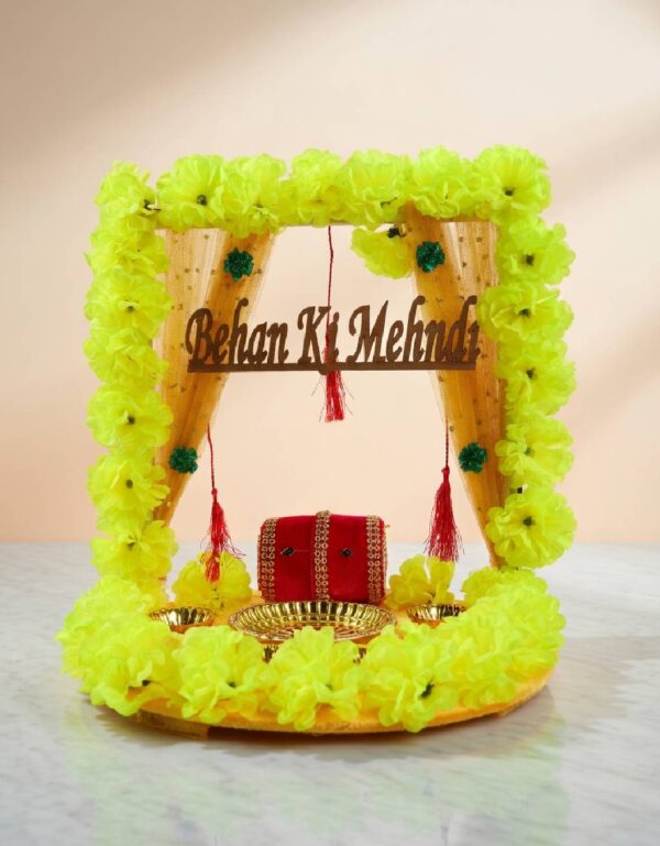 Festive Mehndi Rasam decorative wedding plate features arches, bowls, and floral accents.